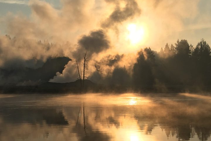 a large body of water with smoke coming out of it