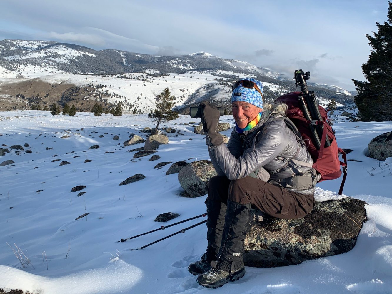 a person sitting on top of a snow covered slope