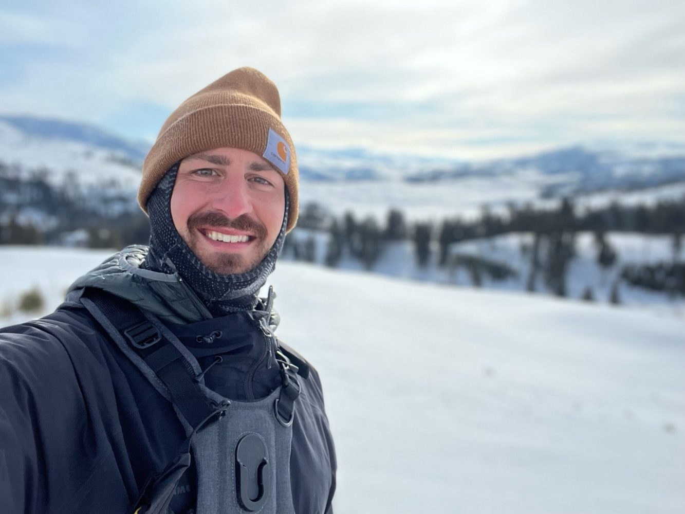 a man that is standing in the snow