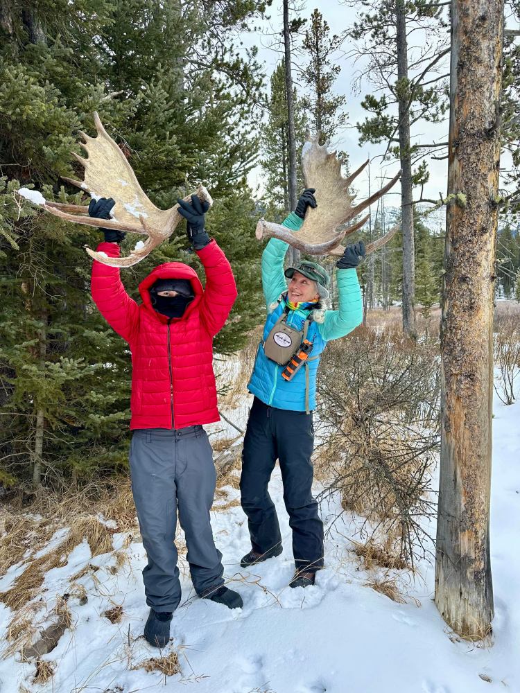 a couple of people that are standing in the snow